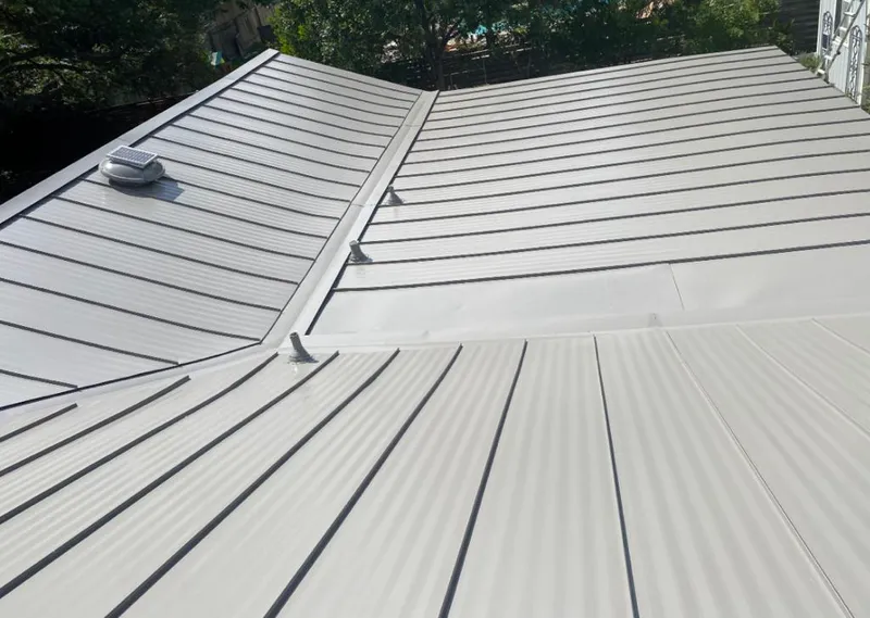 Solar attic fan installed on a metal roof for Roof Ventilation in Glencoe